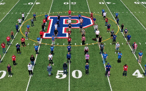  Picture of the Page High faculty standing in lines on the Page High football field.  